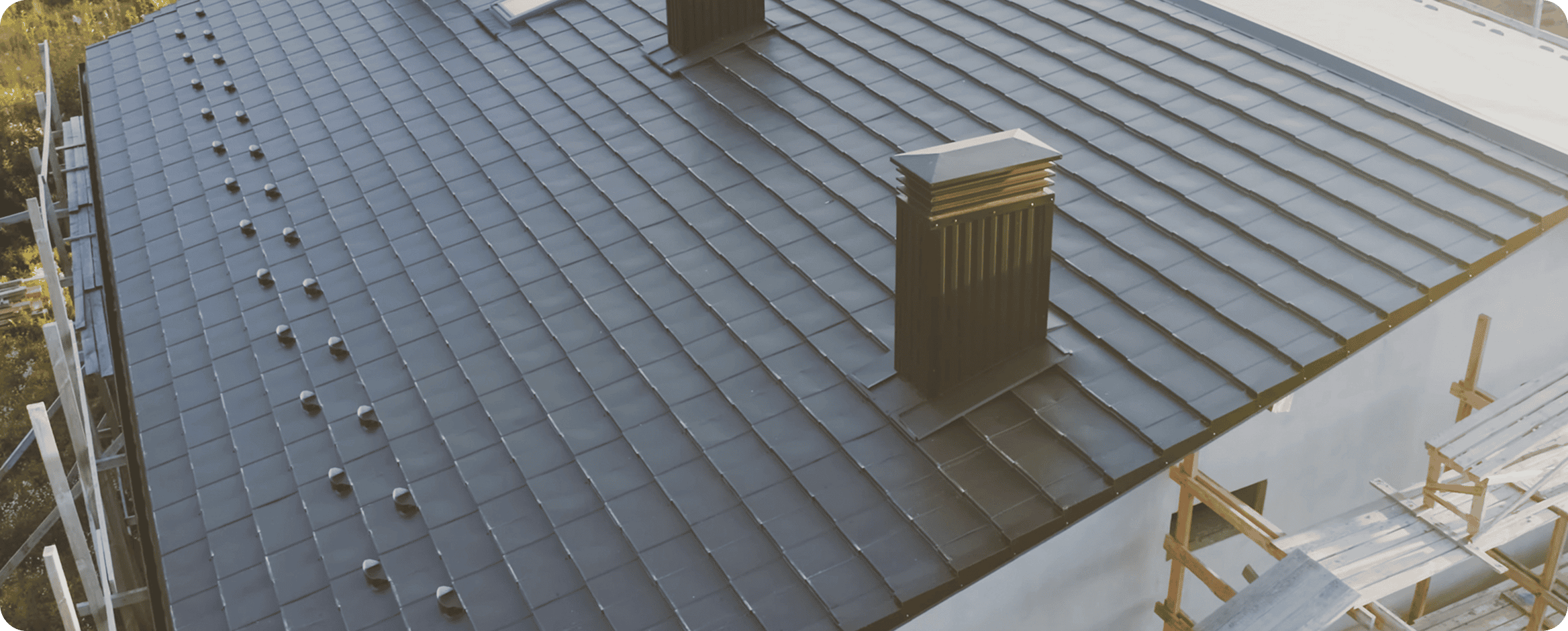 Modern house roof with dark shingles.