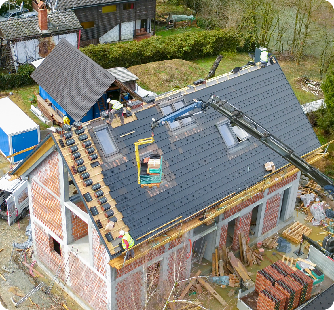 House with workers installing a new roof.