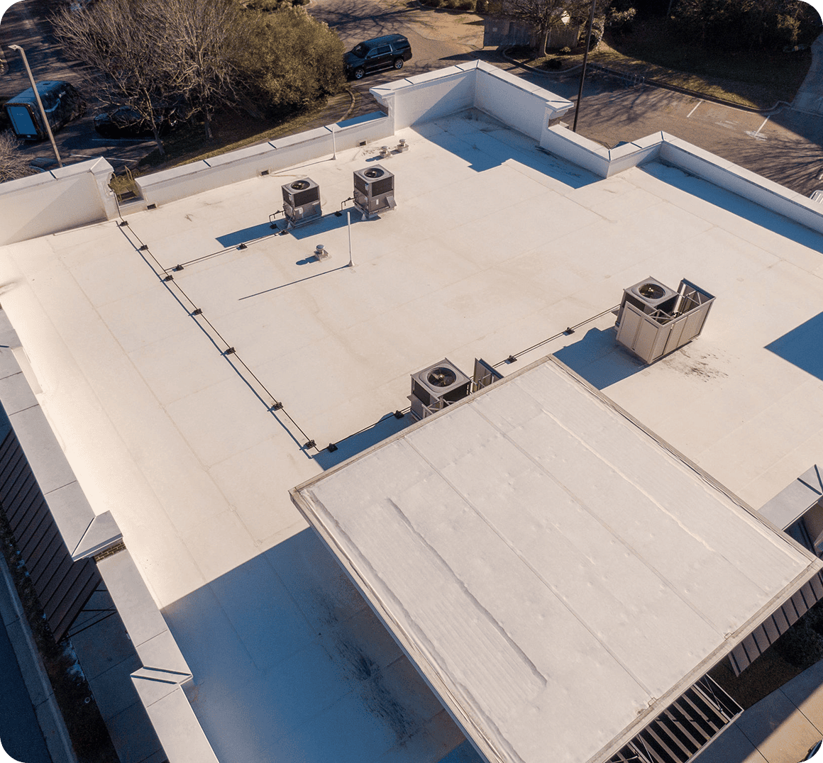 Rooftop with HVAC units and clear sky.