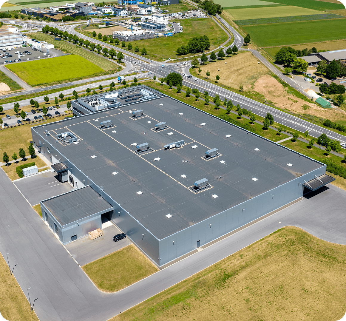 Large industrial building with surrounding roads.