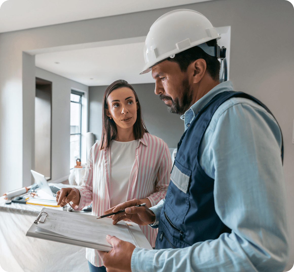 Construction worker and woman discussing renovation plans.